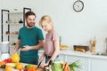 smiling couple of vegans preparing food