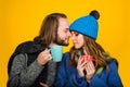 Smiling couple in warm clothes drinking tea. Bearded man and young woman in knitted sweater and scarf with cup of hot Royalty Free Stock Photo