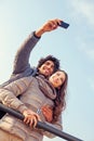 Smiling Couple will making a selfie embraced