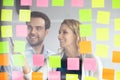 Smiling coworkers writing tasks on sticky papers, post it notes Royalty Free Stock Photo