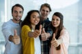 Smiling creative business team showing thumbs up in office Royalty Free Stock Photo