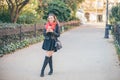 Smiling curvy blond hair woman standing on the street with cup of coffee to go