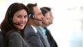 Smiling customer service agents working in a call center