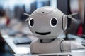 Smiling customer service robot at computer in office with blurred background for text Royalty Free Stock Photo
