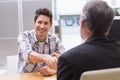 Smiling customer shaking a salesman hand