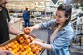 Smiling customers buying sicilian oranges in grocery section Royalty Free Stock Photo