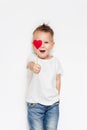 Smiling cute boy in white t-shirt with red heart. Love