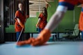 Three janitors doing the cleaning in the office cafe Royalty Free Stock Photo