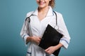 Smiling cute female doctor or nurse holding clipboard Royalty Free Stock Photo