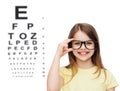 Smiling cute little girl in black eyeglasses Royalty Free Stock Photo