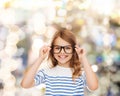 Smiling cute little girl with black eyeglasses