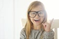 Smiling cute little girl with black eyeglasses over white background Royalty Free Stock Photo