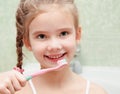 Smiling cute little girl brushing teeth Royalty Free Stock Photo