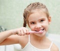 Smiling cute little girl brushing teeth Royalty Free Stock Photo