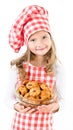 Smiling cute little girl in chef hat holding bowl with cookies Royalty Free Stock Photo