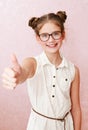 Smiling cute little girl child preteen in eyeglasses with finger up education, school and vision concept isolated Royalty Free Stock Photo