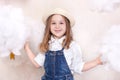 A smiling cute little girl flies in the sky with clouds and stars. Little astrologer Little traveler. The concept of preschool edu Royalty Free Stock Photo