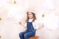 A smiling cute little girl flies in the sky with clouds and stars. Little astrologer Little traveler. The concept of preschool edu Royalty Free Stock Photo