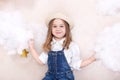 A smiling cute little girl flies in the sky with clouds and stars. Little astrologer Little traveler. The concept of preschool edu