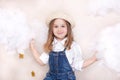 A smiling cute little girl flies in the sky with clouds and stars. Little astrologer Little traveler. The concept of preschool edu Royalty Free Stock Photo