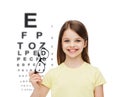 Smiling cute little girl holding black eyeglasses