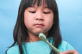 Smiling cute little girl holding toothbrush isolated on blue background. Cute little child brushing teeth. Kid training oral Royalty Free Stock Photo