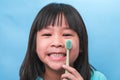 Smiling cute little girl holding toothbrush isolated on blue background. Cute little child brushing teeth. Kid training oral Royalty Free Stock Photo