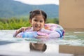 Smiling cute little girl in swimming pool in sunny day Royalty Free Stock Photo