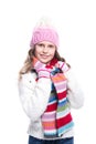 Smiling cute little girl wearing knitted sweater and colorful scarf, hat, mittens isolated on white background. Winter clothes.