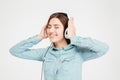 Smiling cute lovely woman using headphones and listening to music Royalty Free Stock Photo