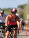 Smiling, cycling woman wearing pink tank-top Royalty Free Stock Photo