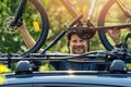 Smiling cyclist mounting his bike on the car roof rack Royalty Free Stock Photo