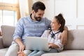 Smiling dad hugging little daughter, laughing at comedy movie. Royalty Free Stock Photo