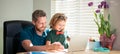 smiling dad and son in glasses use laptop at home. family blog. nerd boy do homework Royalty Free Stock Photo