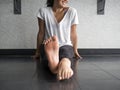 Smiling dancer warming up her feet with alternating pointing and flexing Royalty Free Stock Photo