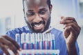 Smiling dark-haired biologist enjoying his activity