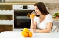 Woman orange juice morning kitchen Royalty Free Stock Photo