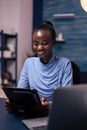 Smiling dark skinned woman browsing on tablet pc Royalty Free Stock Photo