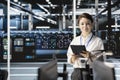 Smiling data center engineer programming diagnostic scripts on tablet Royalty Free Stock Photo