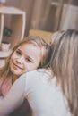 Smiling daughter hugging his mother at home. Concept of couple family is in sorrow Royalty Free Stock Photo