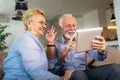 Deaf senior couple talking using sign language on the digital tablet`s cam Royalty Free Stock Photo