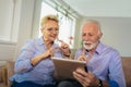 Deaf senior couple talking using sign language on the digital tablet`s cam Royalty Free Stock Photo