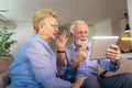 Smiling deaf senior couple talking using sign language on the digital tablet`s cam Royalty Free Stock Photo