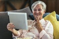 Deaf senior woman talking using sign language on digital tablet Royalty Free Stock Photo