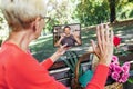 Deaf senior woman talking using sign language on digital tablet in the park Royalty Free Stock Photo