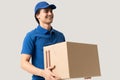 Smiling Delivery Man Carrying Cardboard Box Royalty Free Stock Photo