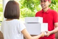 Smiling delivery man delivering parcels to a woman