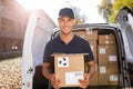 Smiling delivery man loading boxes into his truck Royalty Free Stock Photo