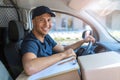 Delivery man sitting in a delivery van Royalty Free Stock Photo