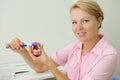 Smiling dentist shows how to correctly brush teeth